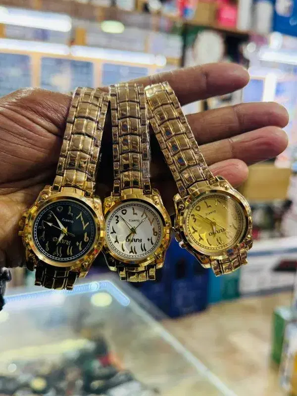 gold-tone quartz watches with arabic numerals on the dails