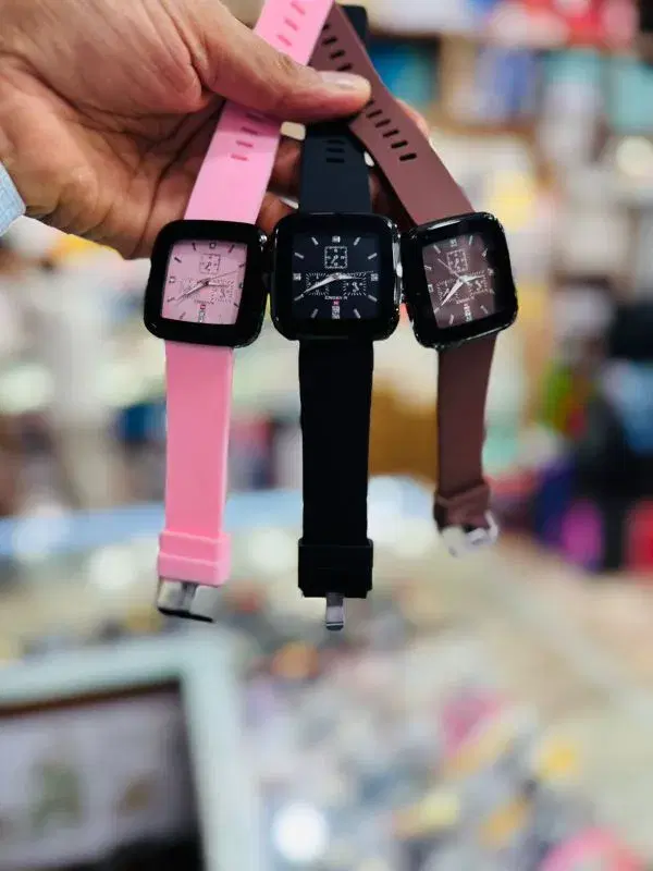 three square-face quartz watches with durable rubber straps in pink, black, and brown.