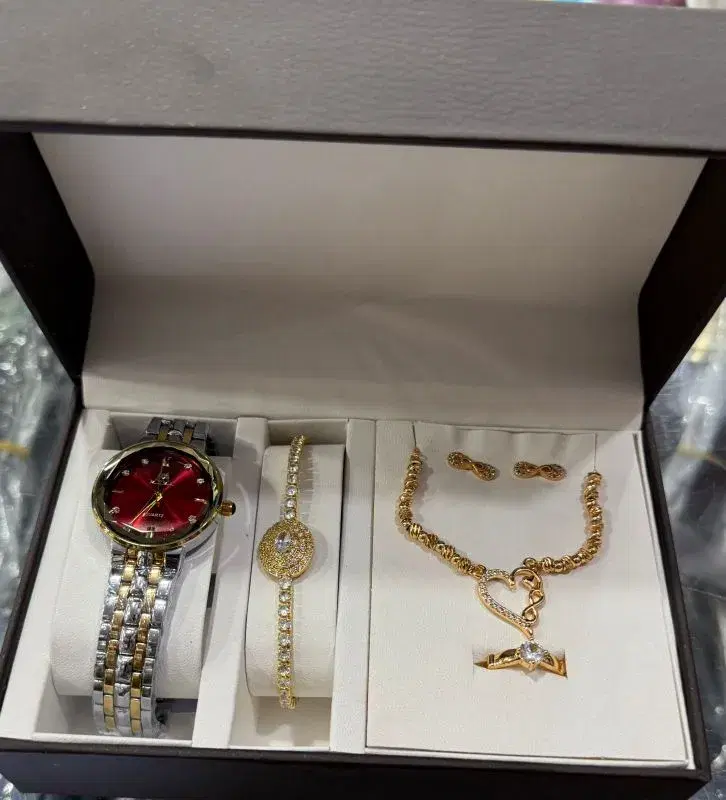 four-piece gold-plated jewelry set featuring a watch with a red face