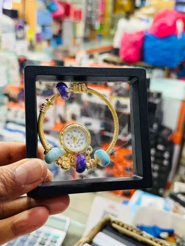 bracelet watch featuring colorful beads and a heart charm.