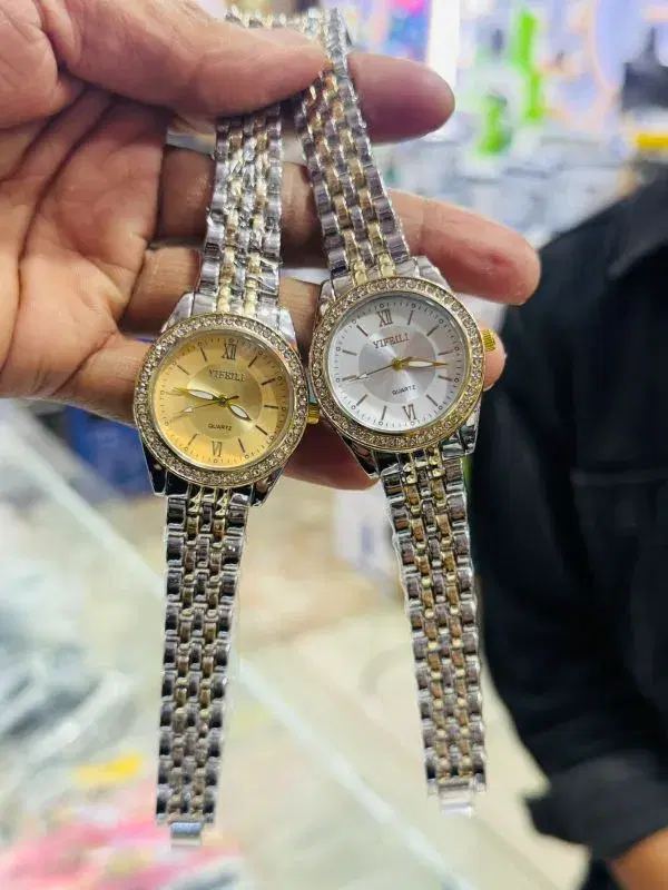 quartz watches feature a two-tone stainless steel bracelet and a crystal-set bezel.