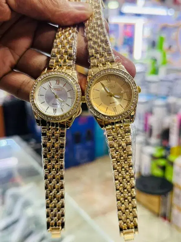 Yifeili quartz analog wristwatch featuring a mixed metal, two-tone stainless steel bracelet and a diamante-encrusted bezel.