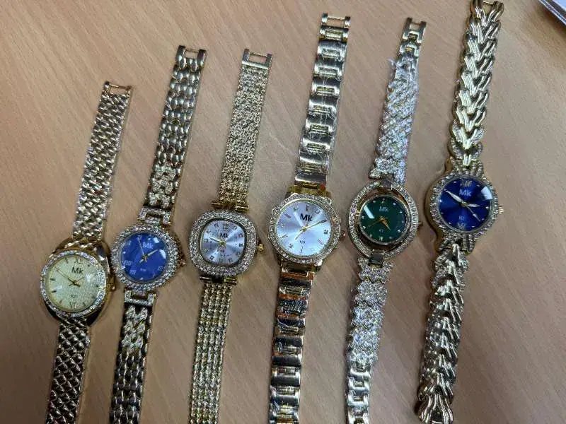 stylish ladies' analog wristwatch, similar in design to various decorative square-faced models featuring rhinestones and metal straps.