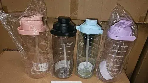 plastic motivational water bottles, often sold in sets, featuring time markers to encourage daily hydration.