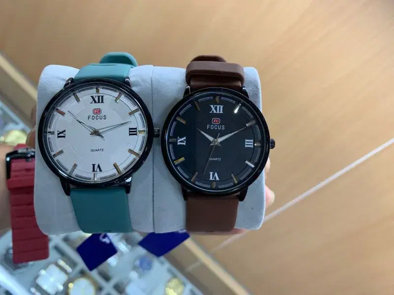 Focus quartz wristwatches feature minimalist analog dials and leather straps.