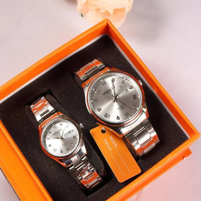 Miracle features a silver dial with a day-date display and a metal bracelet strap.