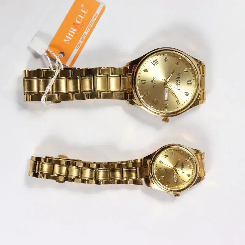 Miracle Time quartz watch, featuring a gold-toned stainless steel band and analog display.