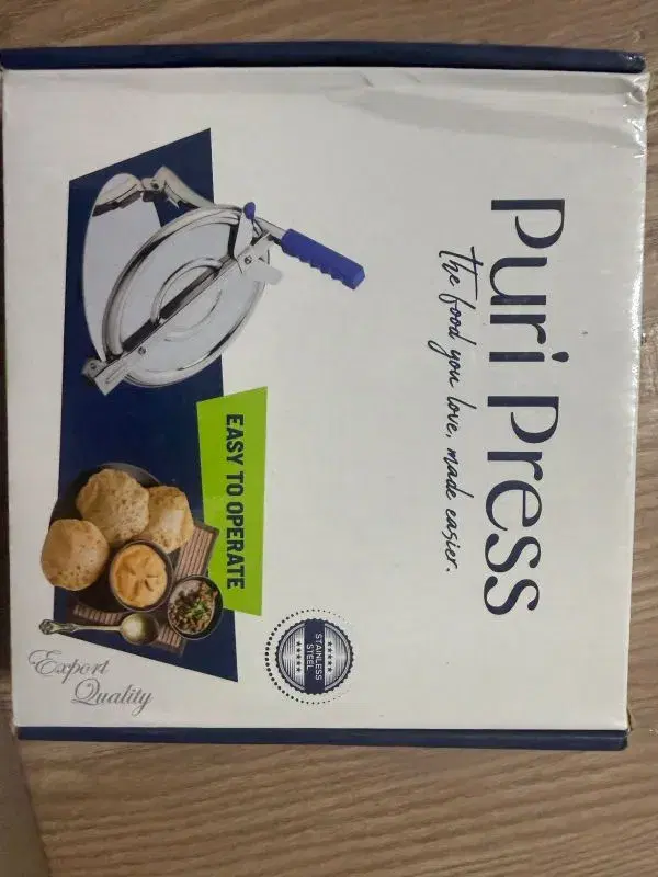 Stainless steel Puri Press, a manual kitchen tool designed for flattening dough to make puris, papads, or small rotis.