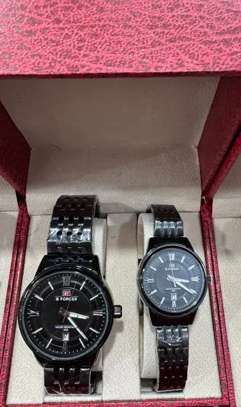 couple watch set features a blue dial with gold accents and a two-tone stainless steel bracelet.