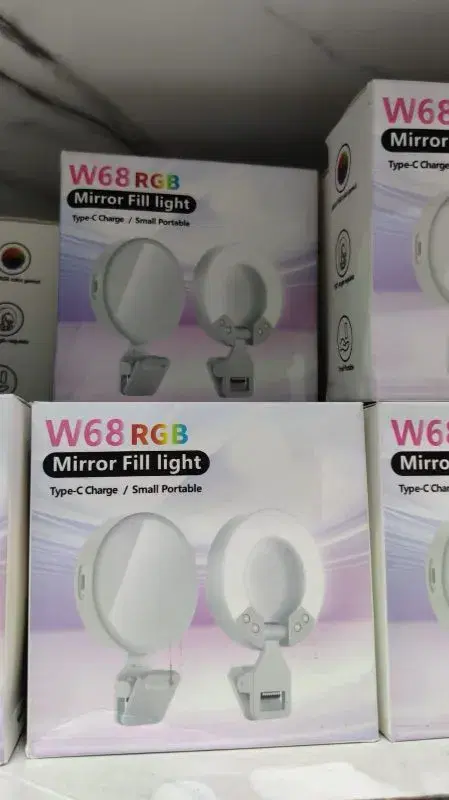 HOCO W68 RGB Mirror Fill Light, a portable device that combines a vanity mirror with a surrounding LED light for selfies or video calls.