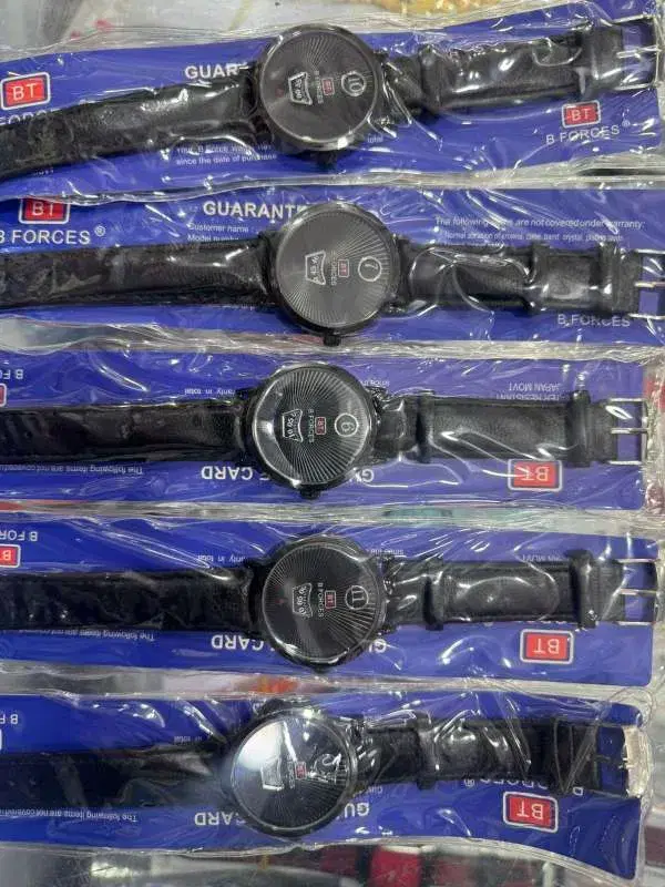 B Forces quartz wristwatches with black leather straps and round analog dials.