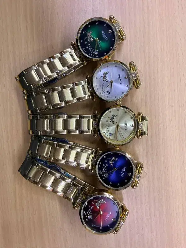 women's gold-toned stainless steel wristwatches featuring a "Miracle" brand dial with butterfly and crystal embellishments.