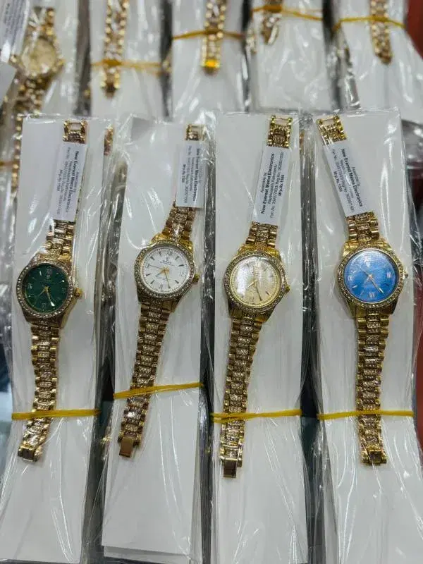 women's watches feature a gold-colored band and a rhinestone-encrusted bezel,