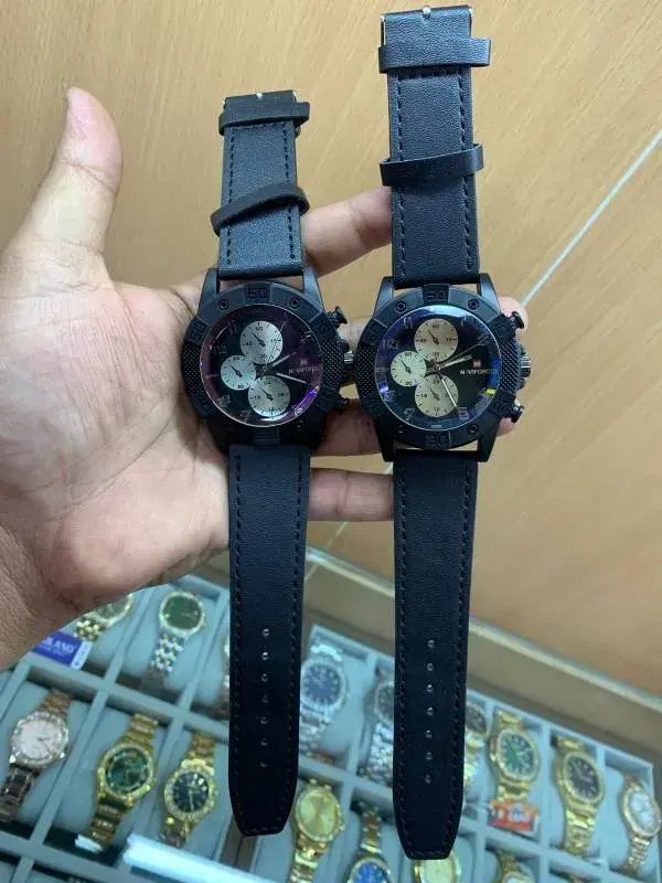 Naviforce branded watches featuring black cases and leather straps.