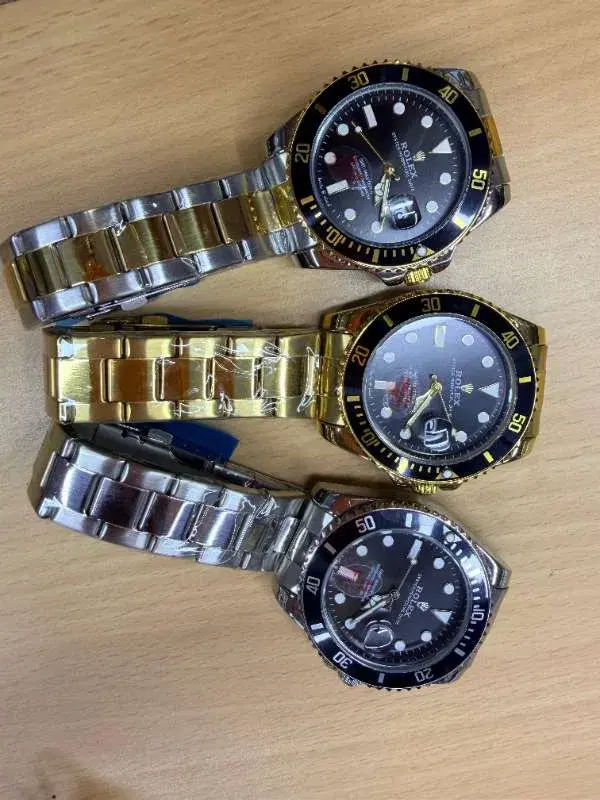 Rolex Submariner watches, featuring stainless steel and yellow gold options with black dials.