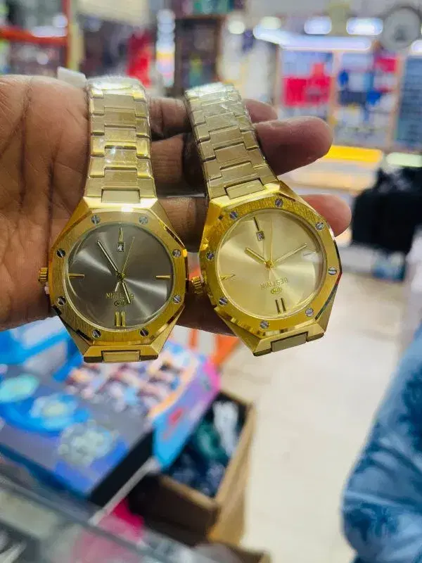 gold-toned metal link watch with an octagonal bezel