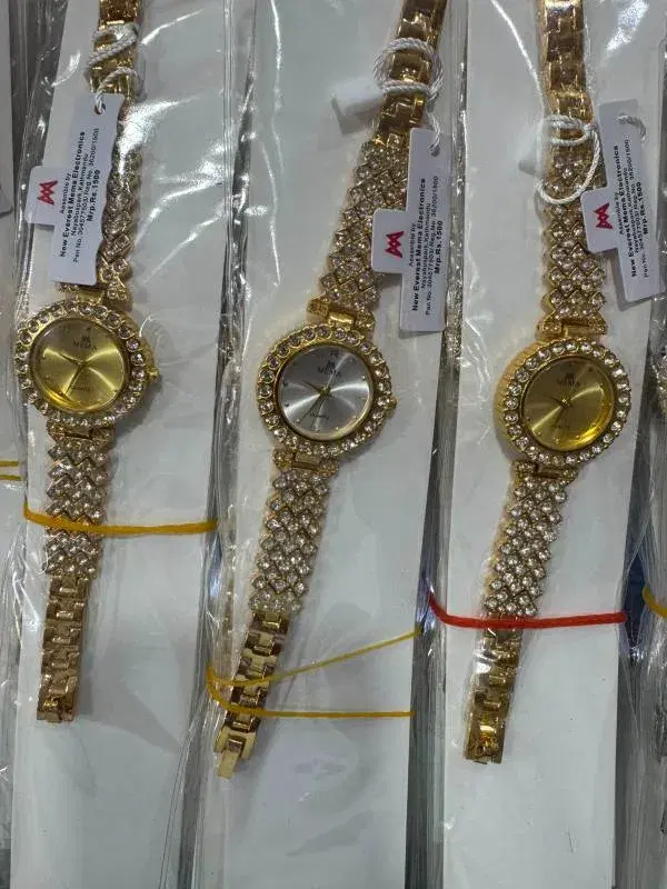 golden, rhinestone-encrusted MEMA brand quartz